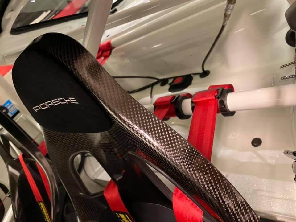 Harness retaining rings behind seats